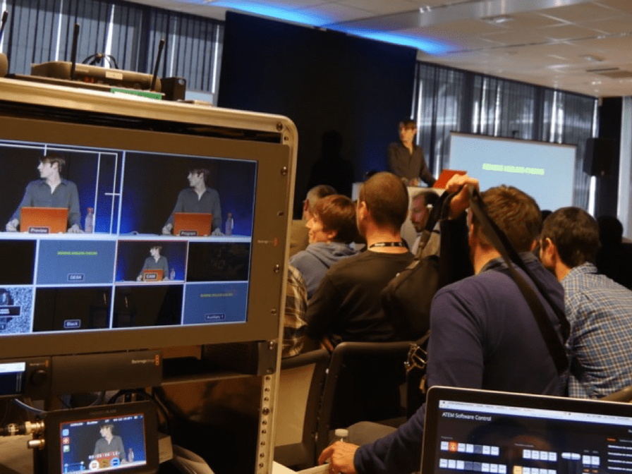 Maxence presenting a technical talk to a conference audience